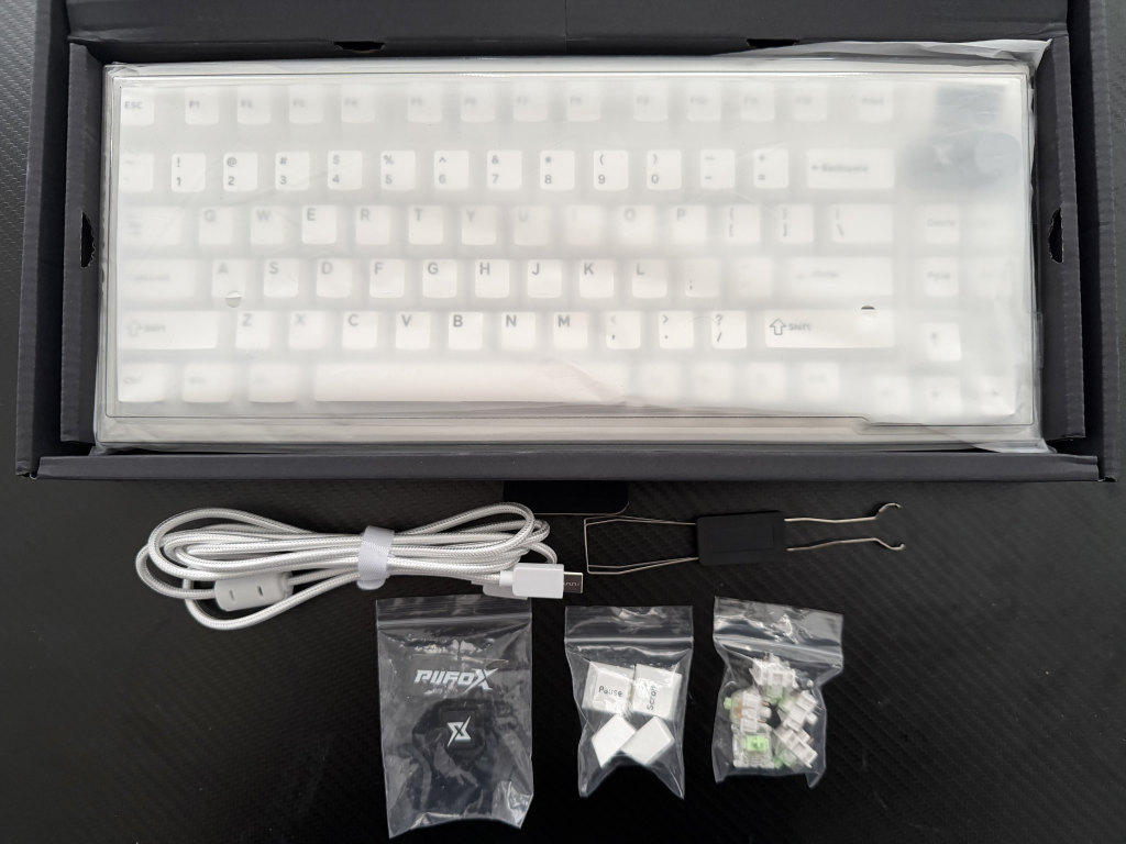 Keyboard with accessories in open box